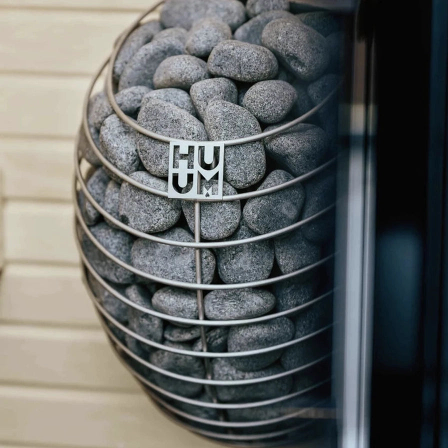 HUUM Drop electric heater installed in a home sauna corner
