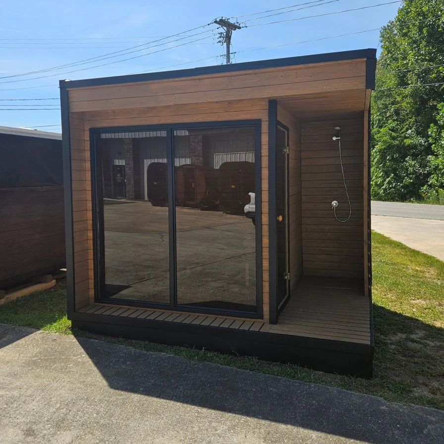 Lux Fjord outdoor sauna angled view showing wood cabin and glass front