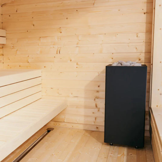 HUUM CORE 10.5kW black electric heater installed in a modern home sauna