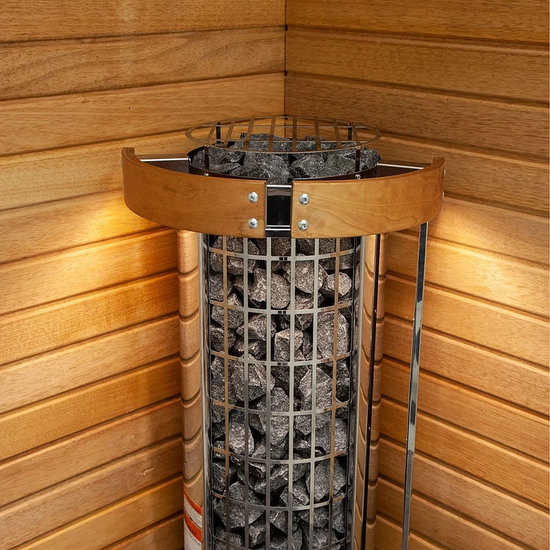 Load image into Gallery viewer, Close-up of Harvia Cilindro 11kW sauna stones inside stainless steel frame corner installed
