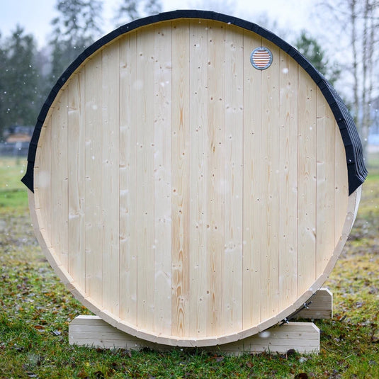 Lumina outdoor sauna side view showing rounded wood body and back vent