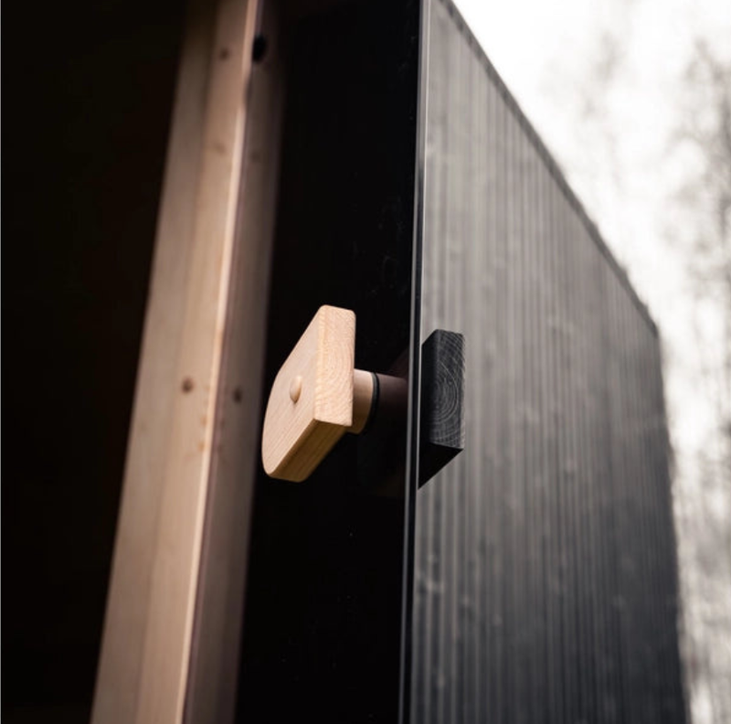 Load image into Gallery viewer, Lux Stromboli outdoor sauna angled view showing dark modern facade

