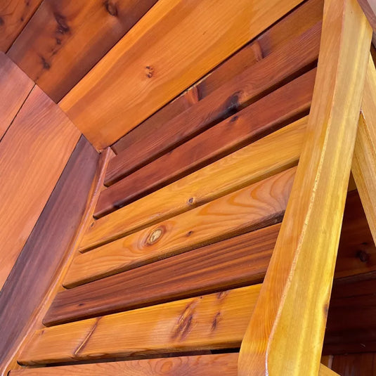 Close-up of 4-person barrel sauna stained bench