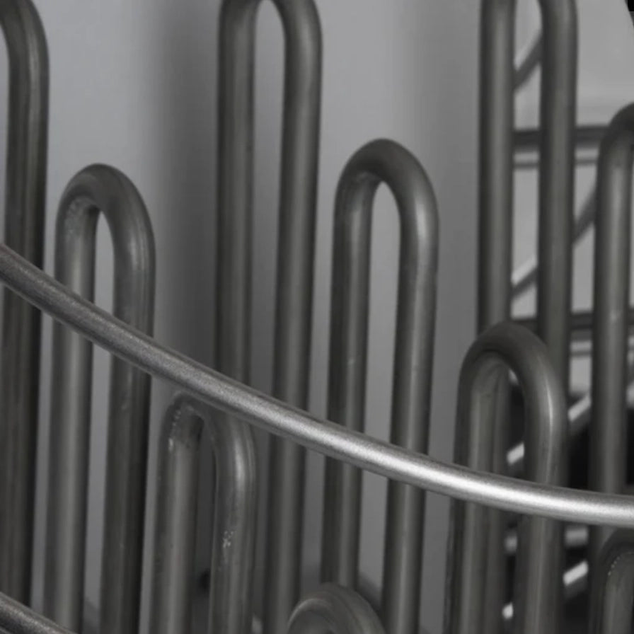 Close-up of HUUM Drop sauna stones in steel mesh frame